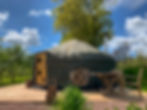 Cai Yurt and outdoor seating area next to apple and quince trees on a sunny day.jpg