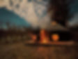People enjoying a firepit next to Cai Yurt at nightime under a starry sky at Phonere